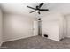 Spacious bedroom featuring plush carpet, neutral walls, and a ceiling fan at 143 W Ray Rd, Chandler, AZ 85225