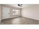 Cozy bedroom showcasing wood-look tile flooring and natural light from the window at 143 W Ray Rd, Chandler, AZ 85225