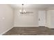 Dining room featuring modern lighting and wood-look tile flooring at 143 W Ray Rd, Chandler, AZ 85225