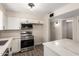 Well-lit kitchen boasts stainless steel appliances, white cabinetry, and modern finishes at 143 W Ray Rd, Chandler, AZ 85225