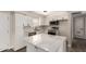 Modern kitchen featuring white cabinets, quartz countertops, and stainless steel appliances at 143 W Ray Rd, Chandler, AZ 85225
