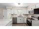 Bright kitchen featuring stainless steel appliances, white cabinetry and modern finishes at 143 W Ray Rd, Chandler, AZ 85225