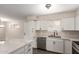 Bright kitchen features white cabinets, stainless appliances, and marble countertops at 143 W Ray Rd, Chandler, AZ 85225