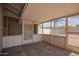 Enclosed patio featuring neutral screens and decor with access to the backyard and natural light at 143 W Ray Rd, Chandler, AZ 85225