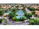 Aerial view showcasing multiple tennis courts surrounded by lush greenery and residential buildings at 1502 E Treasure Cove Dr, Gilbert, AZ 85234