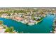 Gorgeous aerial view of lakefront homes with manicured lawns, waterfront access, and lush trees at 1502 E Treasure Cove Dr, Gilbert, AZ 85234