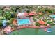 An aerial view of a pool, a lake, and some houses, all surrounded by lush greenery at 1502 E Treasure Cove Dr, Gilbert, AZ 85234