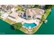 Aerial view of a luxurious waterfront estate with a sparkling pool, lush landscaping, and boat dock at 1502 E Treasure Cove Dr, Gilbert, AZ 85234