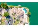 Aerial view of a luxury waterfront property with a private pool, lush landscaping, and boat dock at 1502 E Treasure Cove Dr, Gilbert, AZ 85234