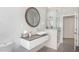 Bright bathroom featuring marble tiling, a floating vanity with vessel sink, and a glass shower at 1502 E Treasure Cove Dr, Gilbert, AZ 85234
