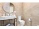 Modern bathroom with marble countertop, round mirror, and neutral-toned tiles at 1502 E Treasure Cove Dr, Gilbert, AZ 85234