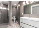 This bathroom features gray tile, a modern vanity, patterned floors, and a frameless shower at 1502 E Treasure Cove Dr, Gilbert, AZ 85234
