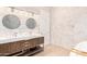 Bright bathroom featuring marble tiling, double sink vanity and modern lighting at 1502 E Treasure Cove Dr, Gilbert, AZ 85234