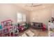 Bright playroom features a daybed, window with shutters, and plenty of toys and games at 1502 E Treasure Cove Dr, Gilbert, AZ 85234