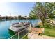 Well-maintained boat docked alongside a beautifully landscaped waterfront property at 1502 E Treasure Cove Dr, Gilbert, AZ 85234