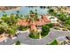 A lovely aerial view of the clubhouse with palm trees, gardens, and ample parking at 1502 E Treasure Cove Dr, Gilbert, AZ 85234