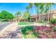 Beautiful entrance with a circular driveway, lush landscaping, and colorful flowers at 1502 E Treasure Cove Dr, Gilbert, AZ 85234