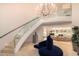 Elegant foyer with soaring ceilings, chandelier, and curved staircase at 1502 E Treasure Cove Dr, Gilbert, AZ 85234