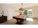 Bright game room featuring a pool table, unique light fixture, and large window with plenty of sunlight at 1502 E Treasure Cove Dr, Gilbert, AZ 85234