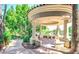 Elegant outdoor gazebo with stone seating, perfect for relaxing in the landscaped backyard at 1502 E Treasure Cove Dr, Gilbert, AZ 85234