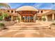 Elegant home with covered entry and stone steps leading to double glass doors at 1502 E Treasure Cove Dr, Gilbert, AZ 85234