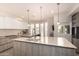 Modern kitchen featuring a large center island, sleek cabinetry, and pendant lighting at 1502 E Treasure Cove Dr, Gilbert, AZ 85234