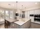 Modern kitchen with a large center island, stainless steel appliances, and bright lighting at 1502 E Treasure Cove Dr, Gilbert, AZ 85234