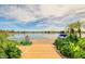Scenic lake view with a wooden dock and lush greenery, creating a serene and inviting atmosphere at 1502 E Treasure Cove Dr, Gilbert, AZ 85234