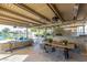 Charming covered outdoor dining area with lake views, modern table, and chairs at 1502 E Treasure Cove Dr, Gilbert, AZ 85234