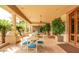 Spacious outdoor patio with comfortable seating, lush greenery, and elegant architectural details at 1502 E Treasure Cove Dr, Gilbert, AZ 85234