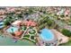 An aerial view of the luxurious resort-style pool area with palm trees and a sandy beach at 1502 E Treasure Cove Dr, Gilbert, AZ 85234