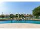Amazing swimming pool with a built in bar and seating surrounded by lush landscaping overlooking the lake at 1502 E Treasure Cove Dr, Gilbert, AZ 85234