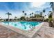 Large, inviting swimming pool with ample seating, palm trees, and a covered area for relaxation at 1502 E Treasure Cove Dr, Gilbert, AZ 85234
