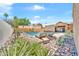 View of a sparkling pool, lush landscaping, and lounge chairs in the backyard at 15226 N 51St St, Scottsdale, AZ 85254