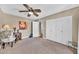 This bedroom features a ceiling fan, closet and an open door to another room at 15226 N 51St St, Scottsdale, AZ 85254
