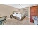 Bedroom featuring a wrought iron bed, neutral colors, carpeted flooring, and an armoire at 15226 N 51St St, Scottsdale, AZ 85254