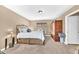 Bedroom featuring a wrought iron bed, neutral colors, an armoire, and carpeted flooring at 15226 N 51St St, Scottsdale, AZ 85254