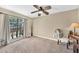 Bright bedroom with a ceiling fan and large window with an exterior view at 15226 N 51St St, Scottsdale, AZ 85254