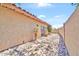 Side exterior of home featuring stucco siding, desert landscaping and a brick walkway at 15226 N 51St St, Scottsdale, AZ 85254