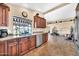 Well-lit kitchen featuring wood cabinets, granite countertops, stainless steel appliances, and an open floorplan at 15226 N 51St St, Scottsdale, AZ 85254
