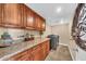 Laundry room featuring granite countertops, wood cabinets, washer and dryer units at 15226 N 51St St, Scottsdale, AZ 85254