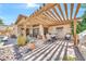 Covered patio featuring brick flooring, a wooden pergola and outdoor furniture with desert landscaping at 15226 N 51St St, Scottsdale, AZ 85254