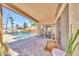 Covered brick patio with view of pool and backyard, desert plants, and dark metal furniture at 15226 N 51St St, Scottsdale, AZ 85254
