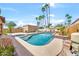 Backyard pool and hot tub with palm trees and desert landscaping under a bright blue sky at 15226 N 51St St, Scottsdale, AZ 85254
