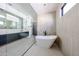 Bright bathroom with glass shower, soaking tub and floating vanity at 1538 W Wagon Wheel Dr, Phoenix, AZ 85021