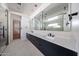 Contemporary bathroom with double vanity, sleek black fixtures, and modern mirrors at 1538 W Wagon Wheel Dr, Phoenix, AZ 85021
