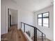 Second story hallway with window, modern railing and wood floors at 1538 W Wagon Wheel Dr, Phoenix, AZ 85021