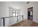 Upstairs hallway with modern railing and wood floors at 1538 W Wagon Wheel Dr, Phoenix, AZ 85021