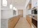 Open kitchen with marble island, stainless steel appliances, and hardwood floors at 1538 W Wagon Wheel Dr, Phoenix, AZ 85021
