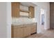 Kitchenette with wooden cabinets, marble countertops and backsplash, and stylish lighting at 1538 W Wagon Wheel Dr, Phoenix, AZ 85021